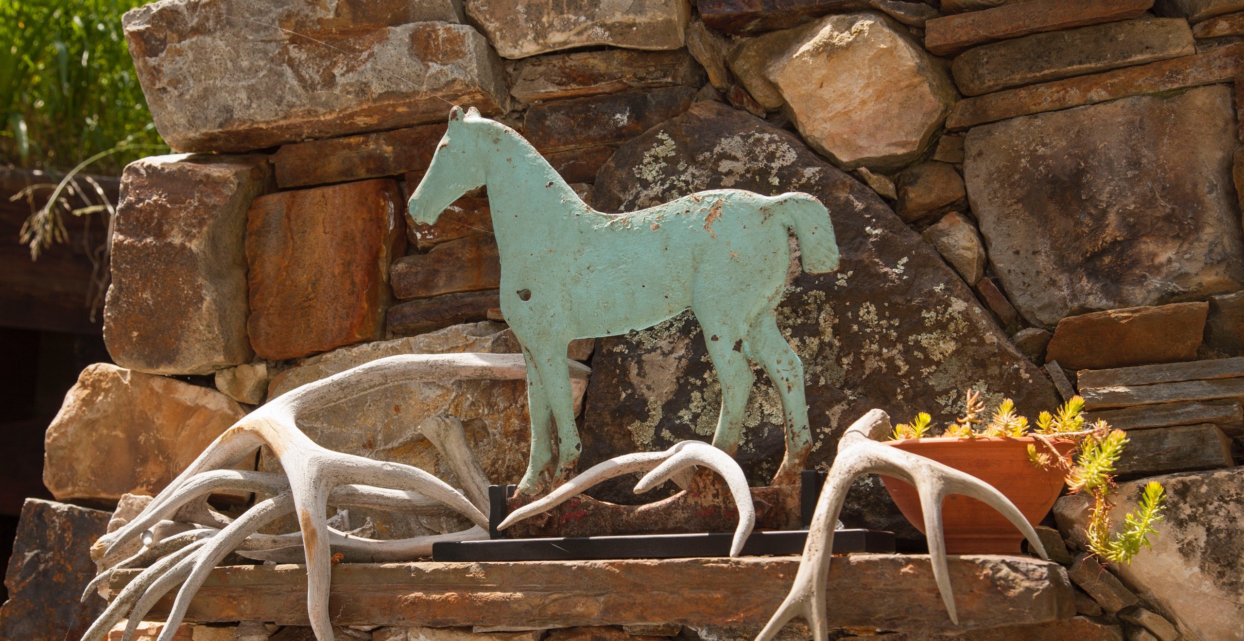 Buffy Birrittella&rsquo;s rustic Utah getaway is home to all kinds of horses&mdash;the one she rides and the ones she collects. Here, a blue horse windmill weight surrounded by antlers