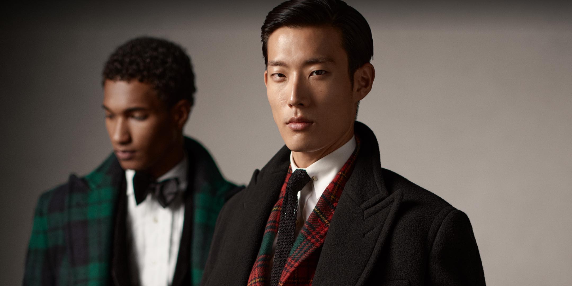 Men wear plaid and black festive Polo attire.